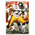 carlton haselrig 1994 fleer 388 Football player in a black and yellow uniform during a game, preparing for a play.