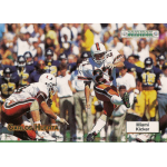 carlos huerta 1992 gridiron rc Miami football kicker in action during a game, surrounded by players and crowd in the background.