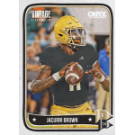 jacurri brown 2024 onyx Vintage football trading card featuring a quarterback in black uniform and yellow helmet, holding a football ready to pass.