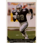 michael irvin 1993 topps gold Football player running on the field in a vintage trading card with a black and silver uniform.