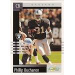 phillip buchanon 2003 score 101 American football player in action on a trading card, wearing a black and silver uniform, running with the ball.