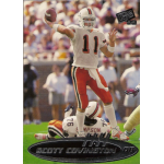 scott covington 1999 press pass rc Football player preparing to throw a pass during a game, with teammates in action on the field.