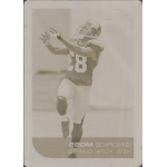 sinorice moss 2006 bowman chrome printing plate magenta Football player in a uniform reaching for the ball during a game, displaying athletic focus and agility.