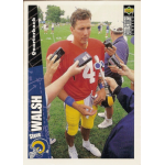 steve walsh 1996 upper deck collectors choice 106 A football player in a red number 4 jersey being interviewed by reporters on a field.