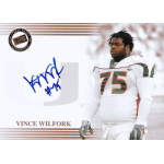 vince wilfork 2004 press pass bronze autograph Football player in a white jersey with number 75 and a signature on a card, wearing protective gear.