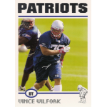 vince wilfork 2004 topps rc Patriots football player number 75 in action on the field, wearing a blue uniform and helmet during practice.