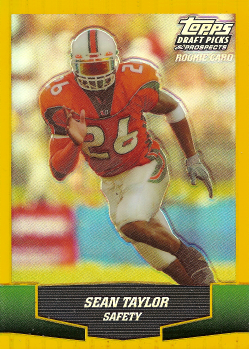 Football player in orange uniform running on a Topps rookie card, labeled Safety with green and yellow accents.