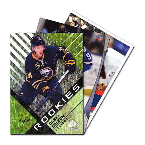 Hockey trading cards featuring a Casey Nelson rookie card in front, held by Buffalo Sabres player.